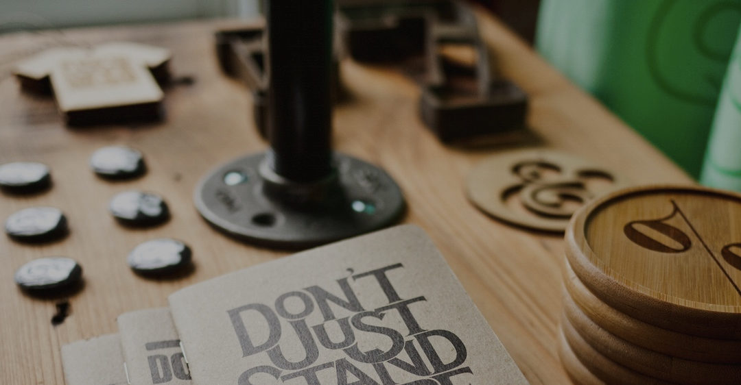 A desk with a book that has "Don't Just Stand There" on the cover