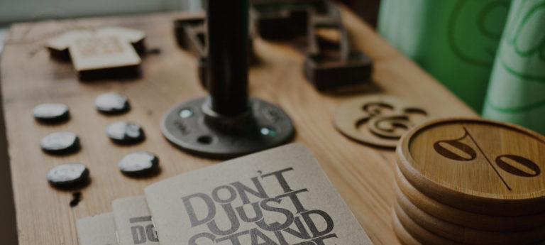 A desk with a book that has "Don't Just Stand There" on the cover