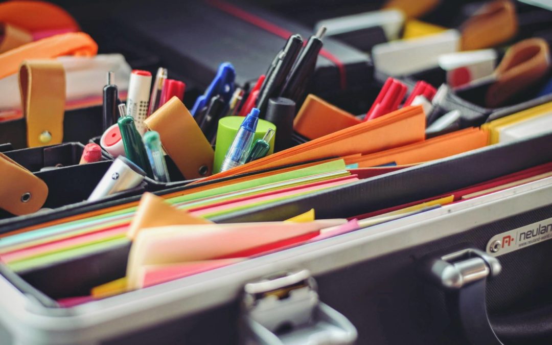 Image of many office supplies in a desk organizer