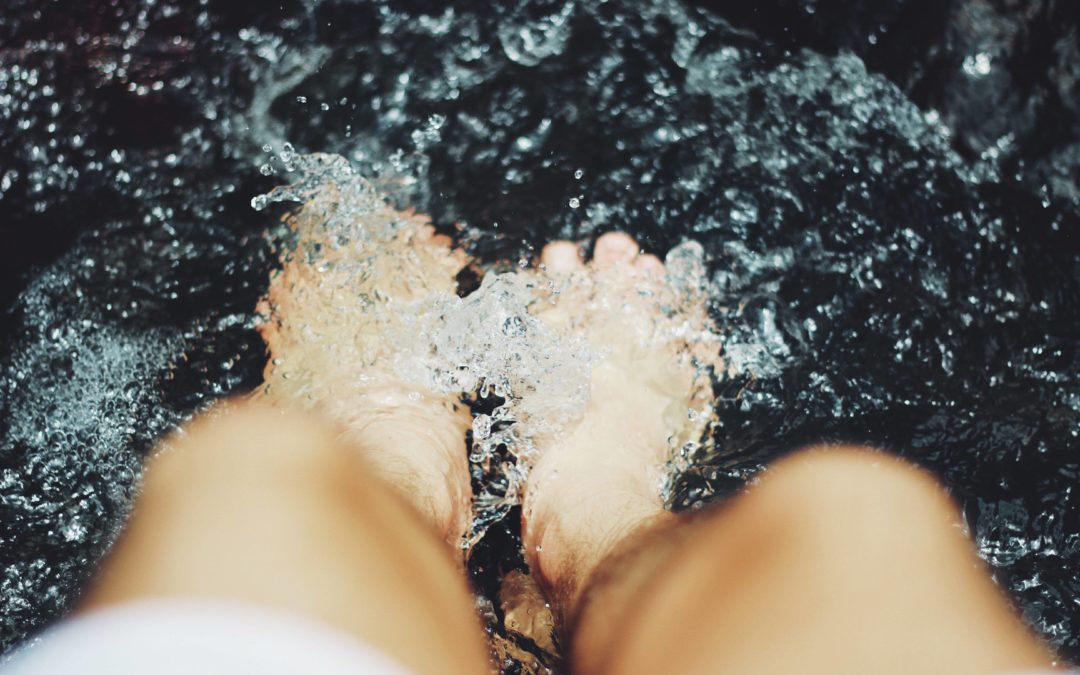 Photo of a woman's feet splashing in water