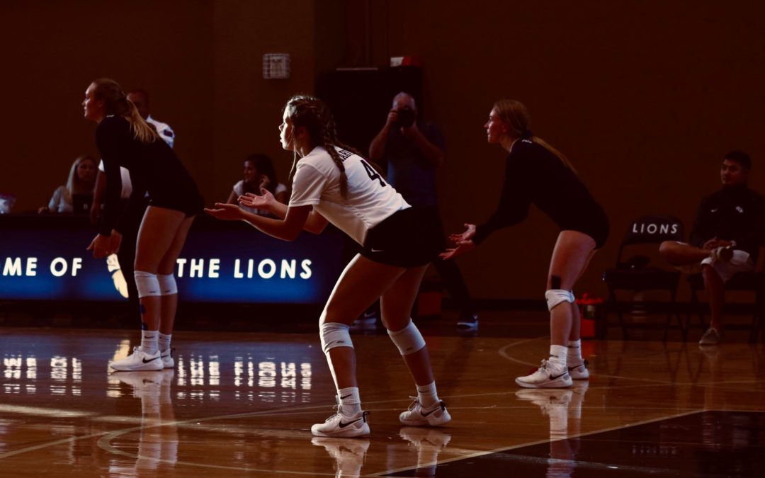 Girls playing indoor volleyball