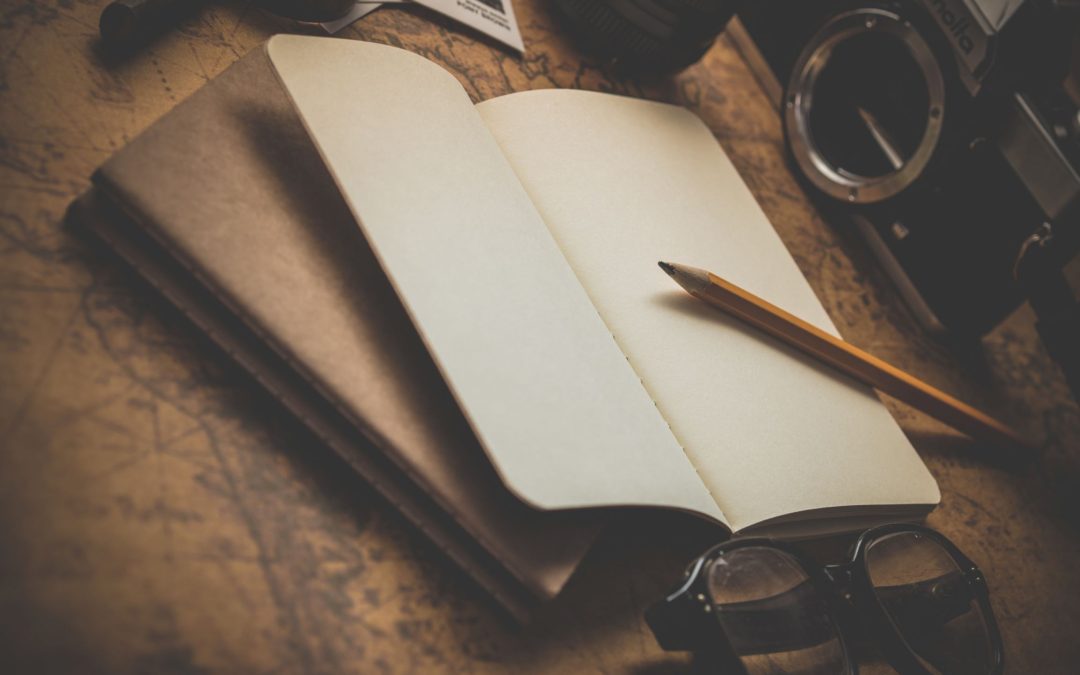 notebook with a pencil and eyeglasses