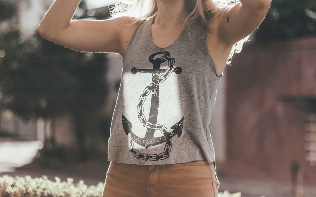 Woman with a grey tshirt with an image of an anchor on it