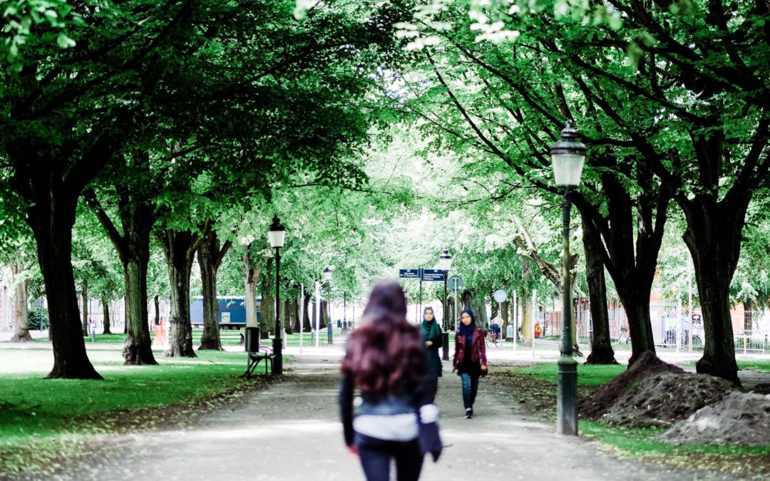 Woman walking along path in the park