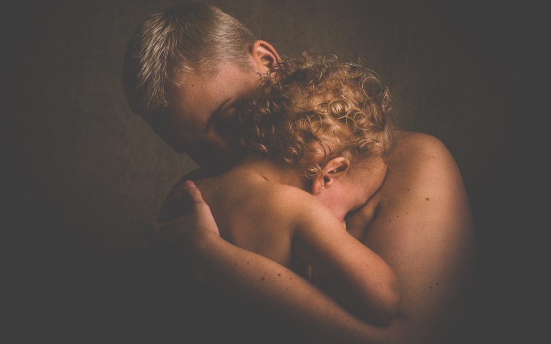 Mother hugging crying child having difficult moments