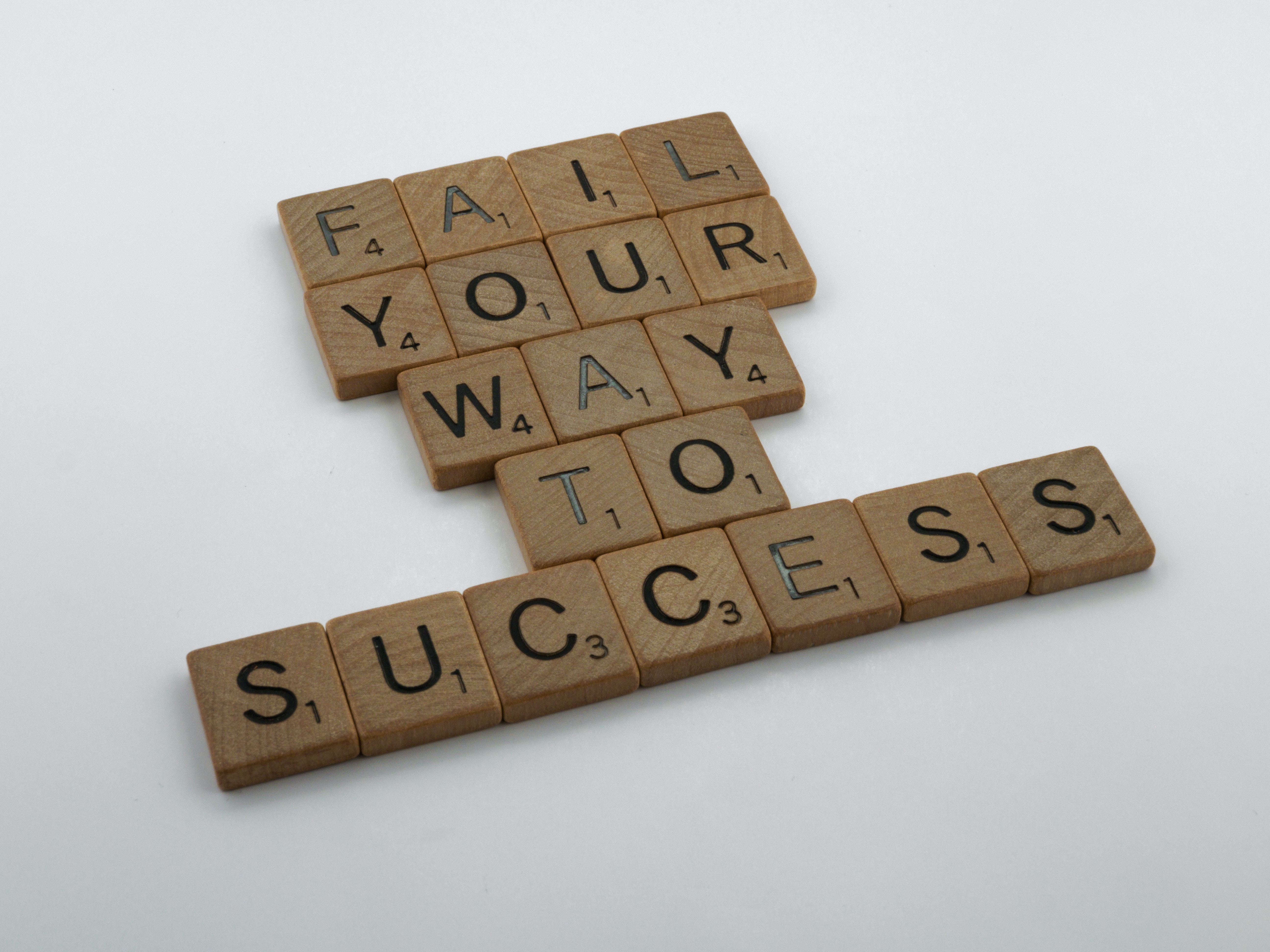 Scrabble tiles that spell out "Fail your way to Success"